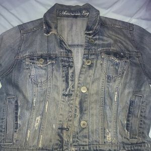 A distressed cropped jean jacket.